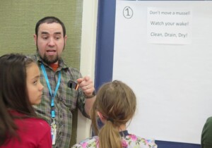 Mr. Peterson helps students interpret relevant slogans: Clean Drain Dry; Watch Your Wake; Dont Move a Mussel.